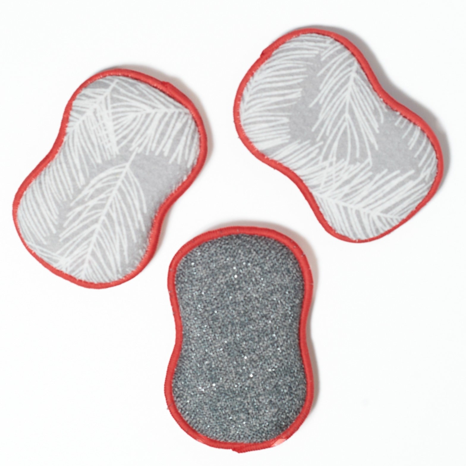 Three washable sponges with red cardinals with red edges on a white background