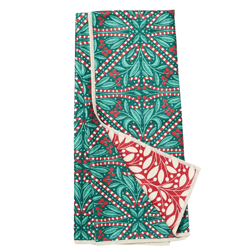Folded tea towel from Rebecca Jane Woolbright with red and green candy cane on a white background