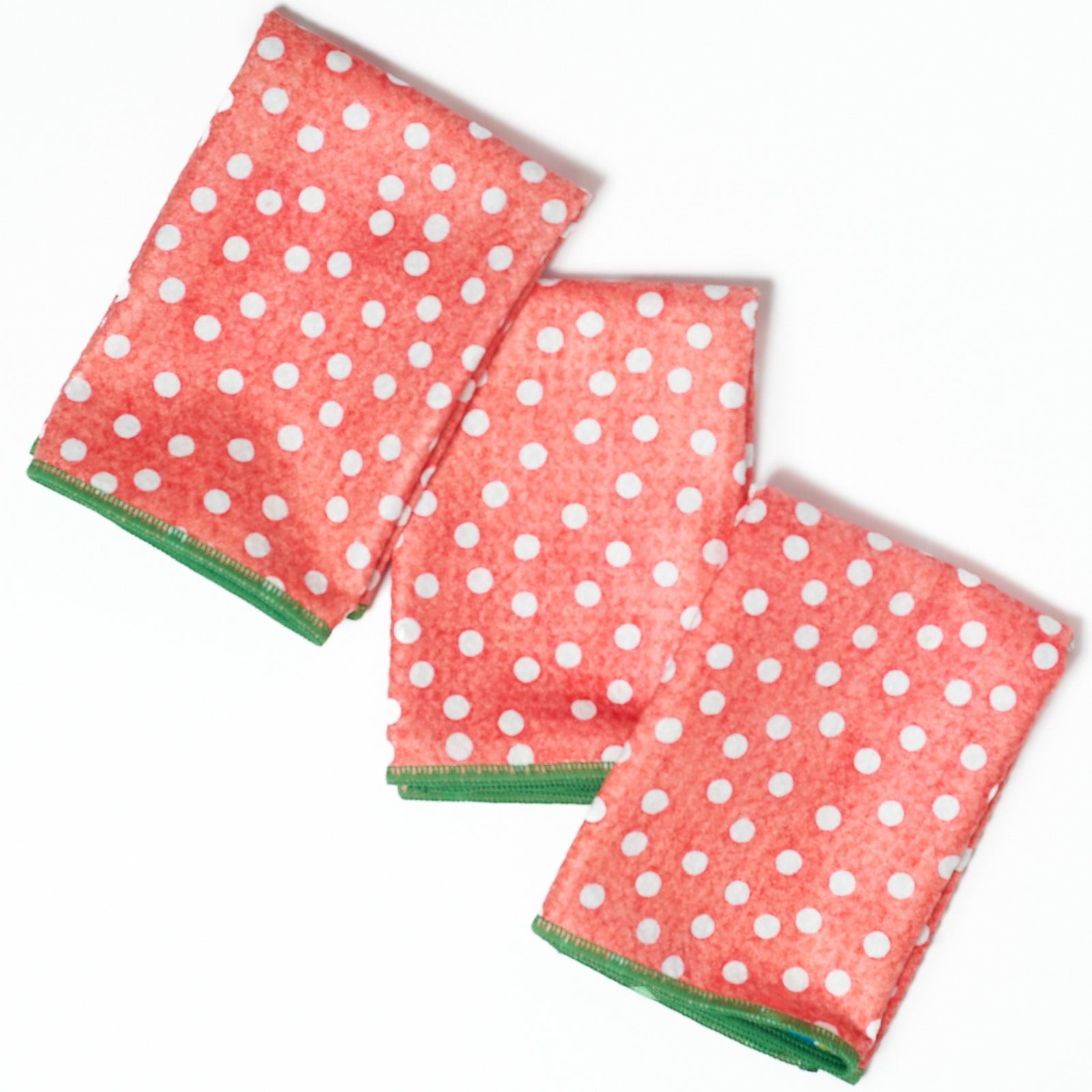 Set of three colorful napkins with holly leaf pattern on a white background from Mary Engelbreit