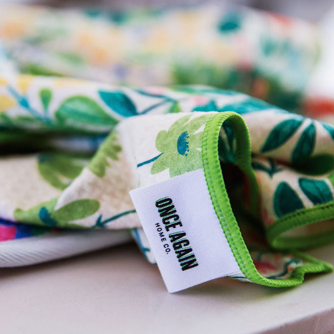 Floral-patterned fabric with a visible brand tag on a light background