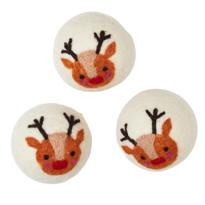 Three dryer balls with reindeer faces on a white background