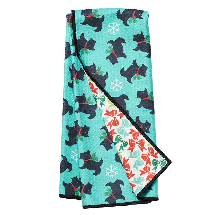 Folded tea towel with black dog pattern on a turquoise background