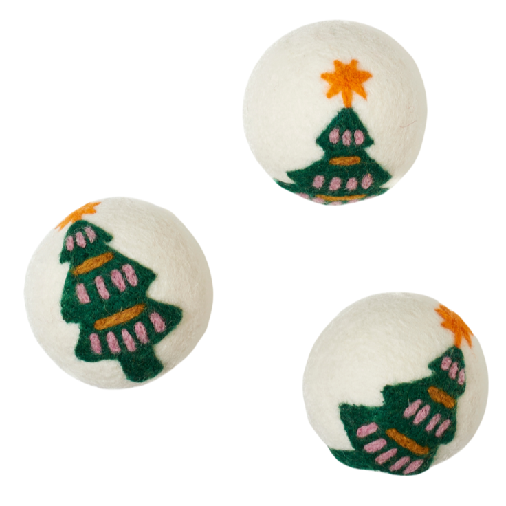 Three dryer balls with Christmas tree designs on a white background