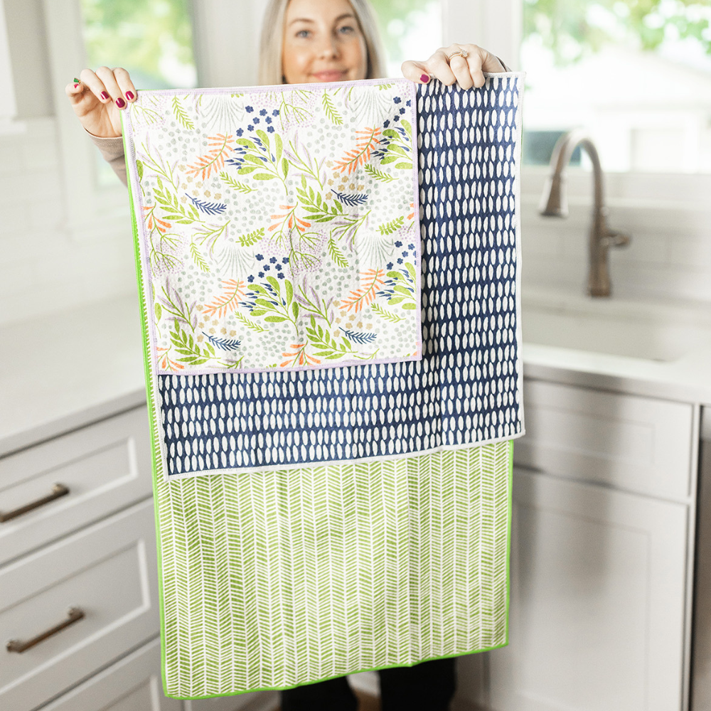 Girl showing 3 sizes of recycled bottle towels