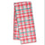Folded tea towel with Christmas tree pattern on a pink background