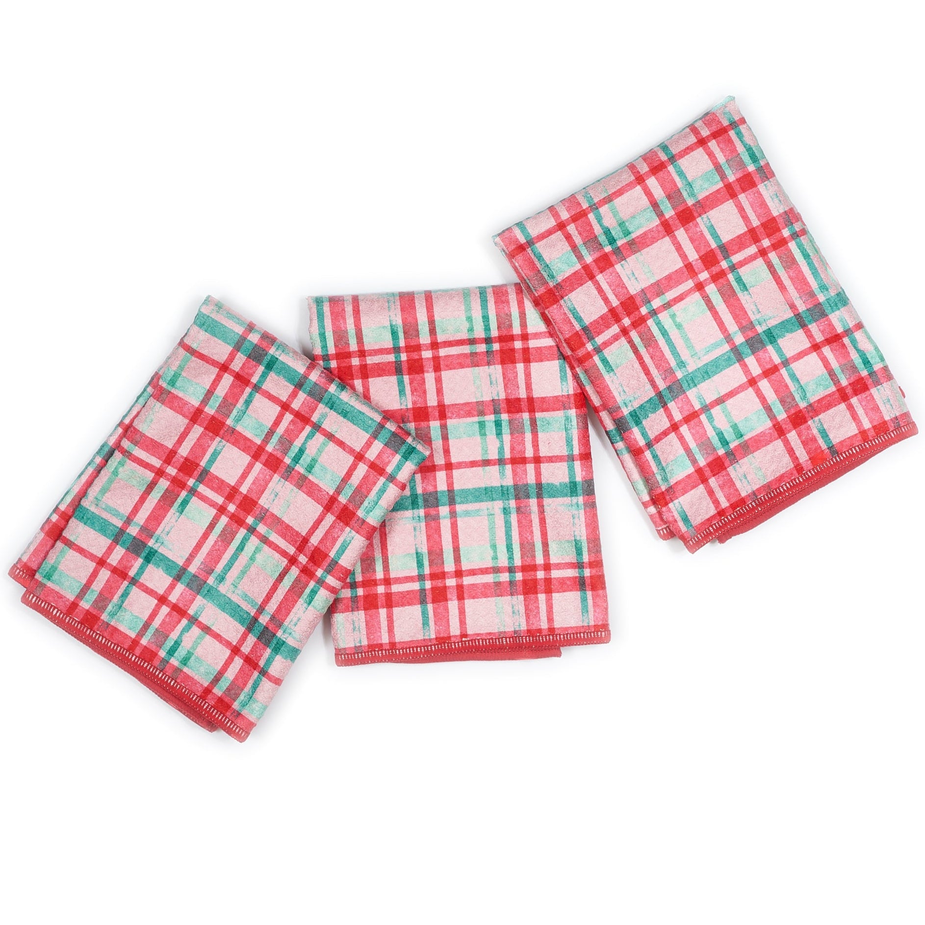 Set of four Christmas-themed napkins with tree patterns on a white background