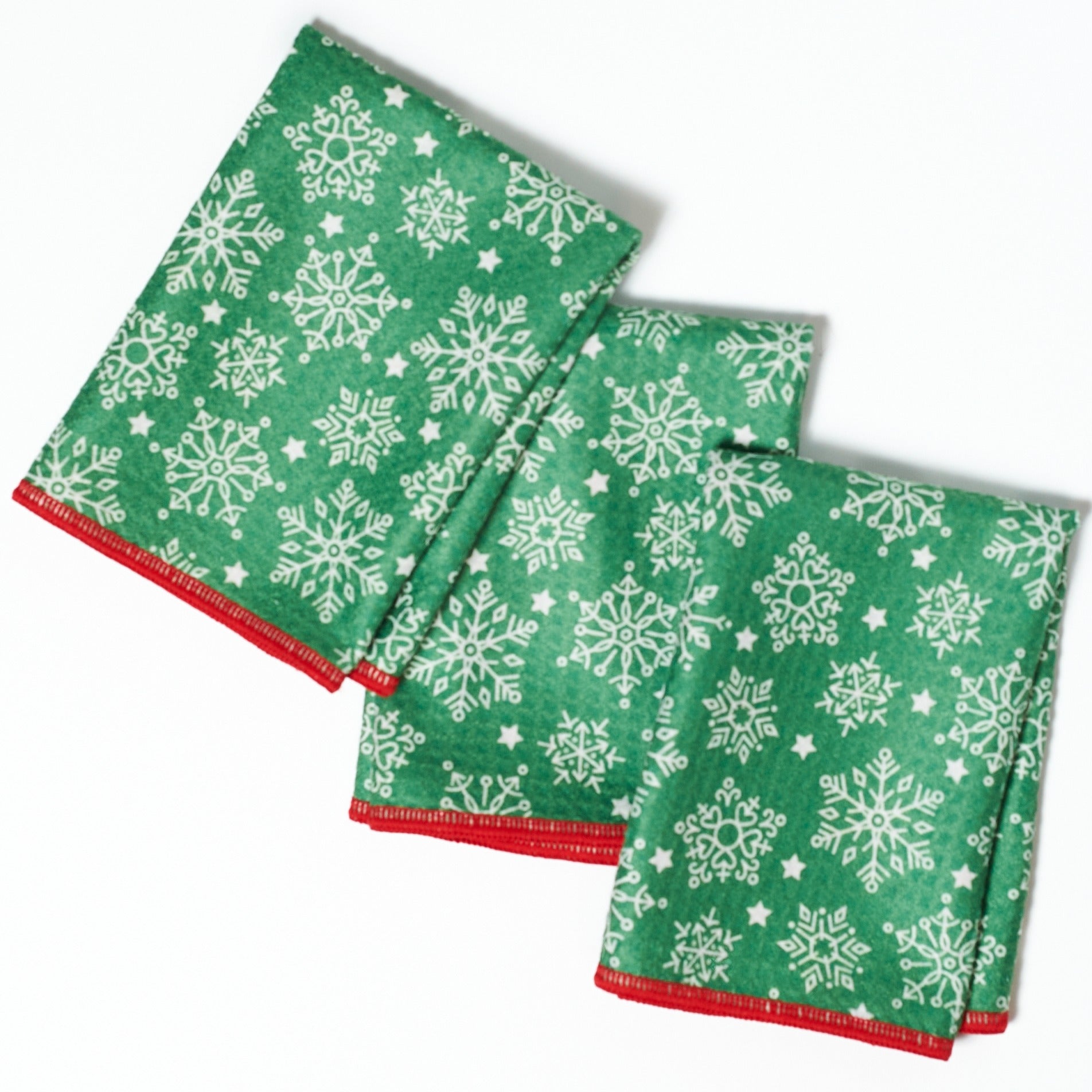 Set of three Christmas-themed napkins with Santa Claus and winter elements on a blue background.