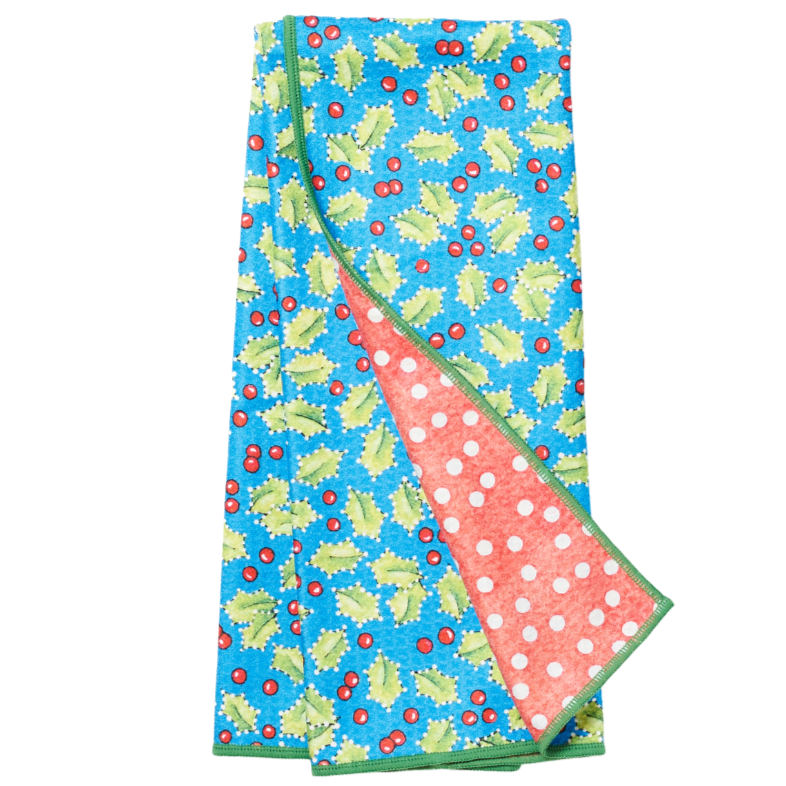 Folded tea towel with holly leaf pattern on a blue background from Mary Engelbreit