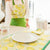 Person wearing a green apron with lemon pattern in a kitchen setting