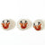 Three dryer balls with reindeer faces on a white background