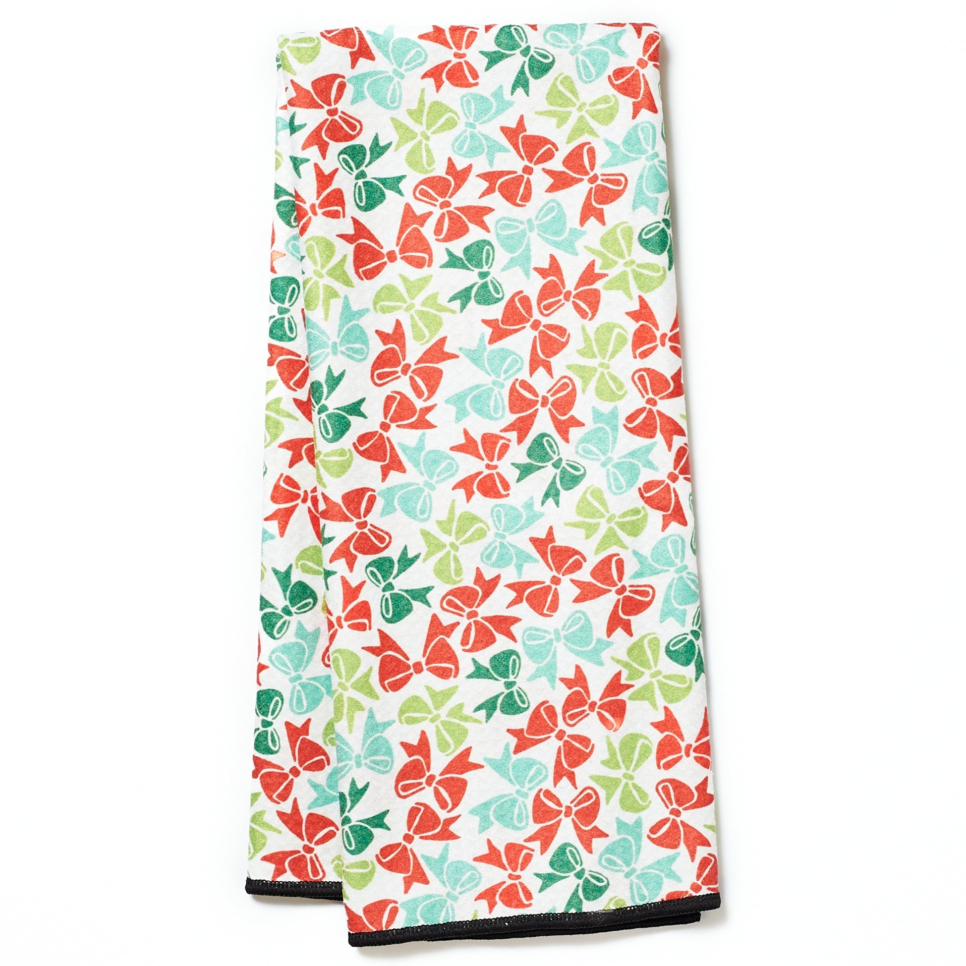Folded tea towel with black dog pattern on a turquoise background
