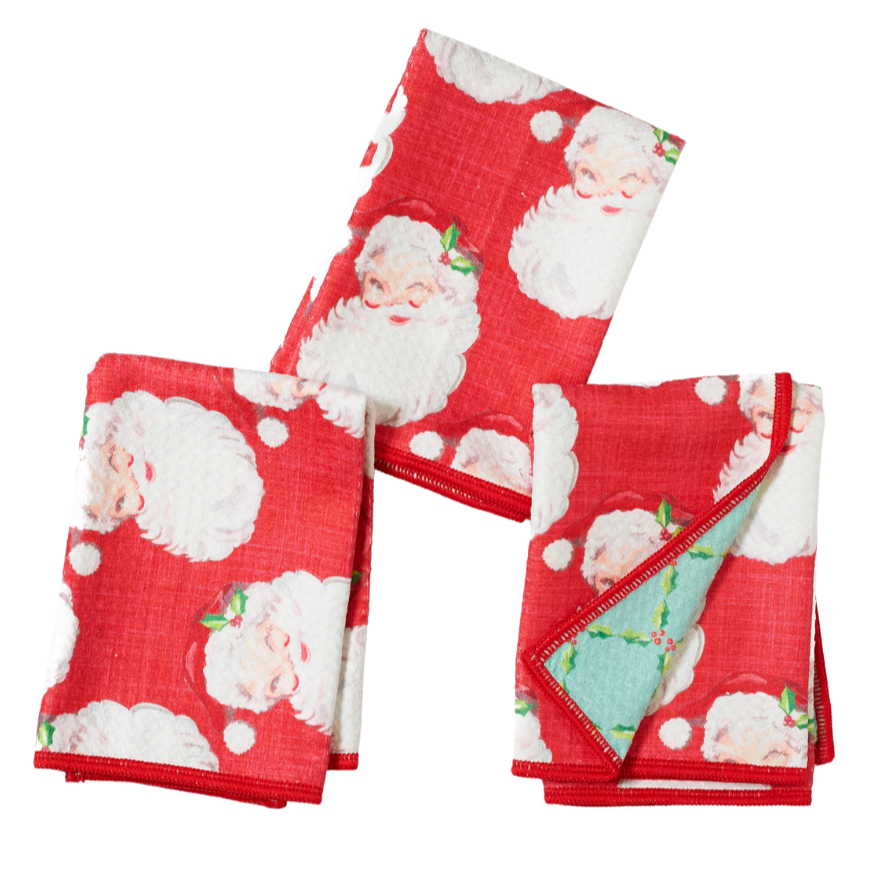 Set of three red napkins with Santa Claus pattern on a white background