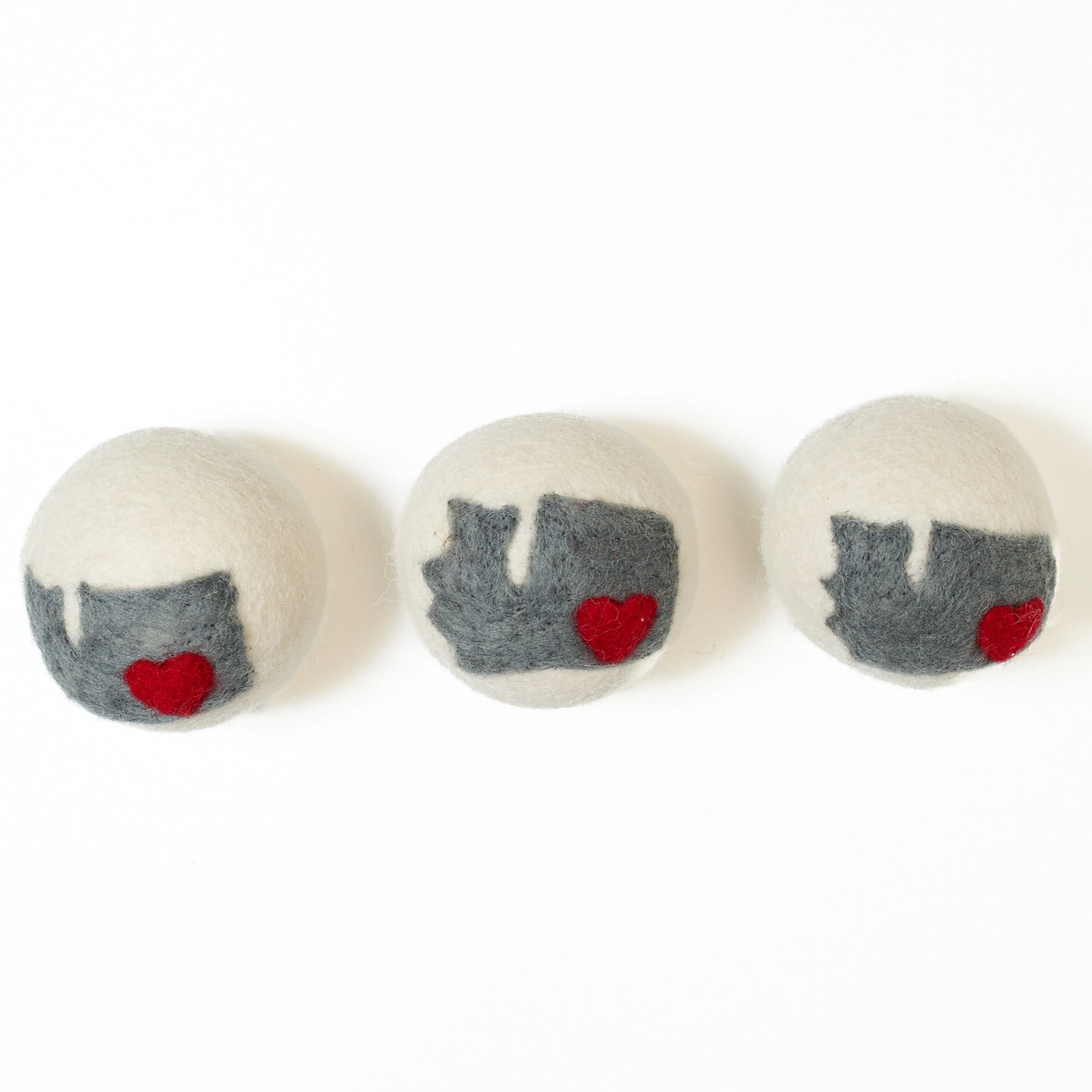 Three dryer balls with Washington state on them