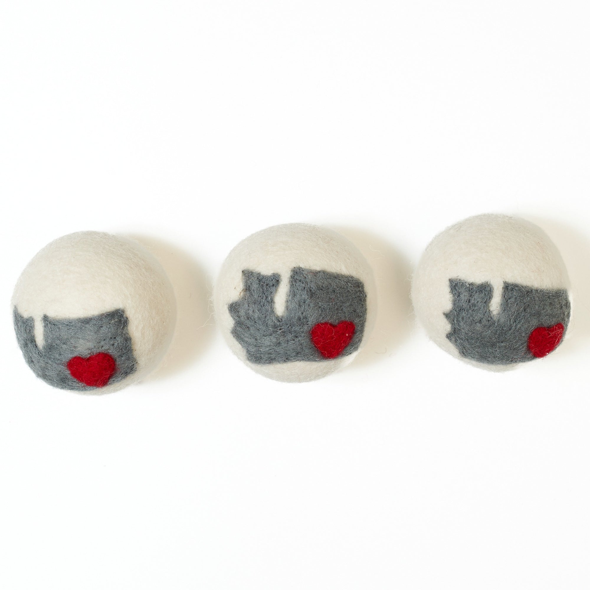 Three dryer balls with Washington state on them